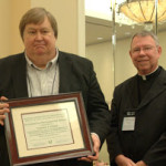 NWCU National Planning Committee Chair, Robert Flannery presents an Ecumenical Recognition Award to the Rev. Thomas Prinz.